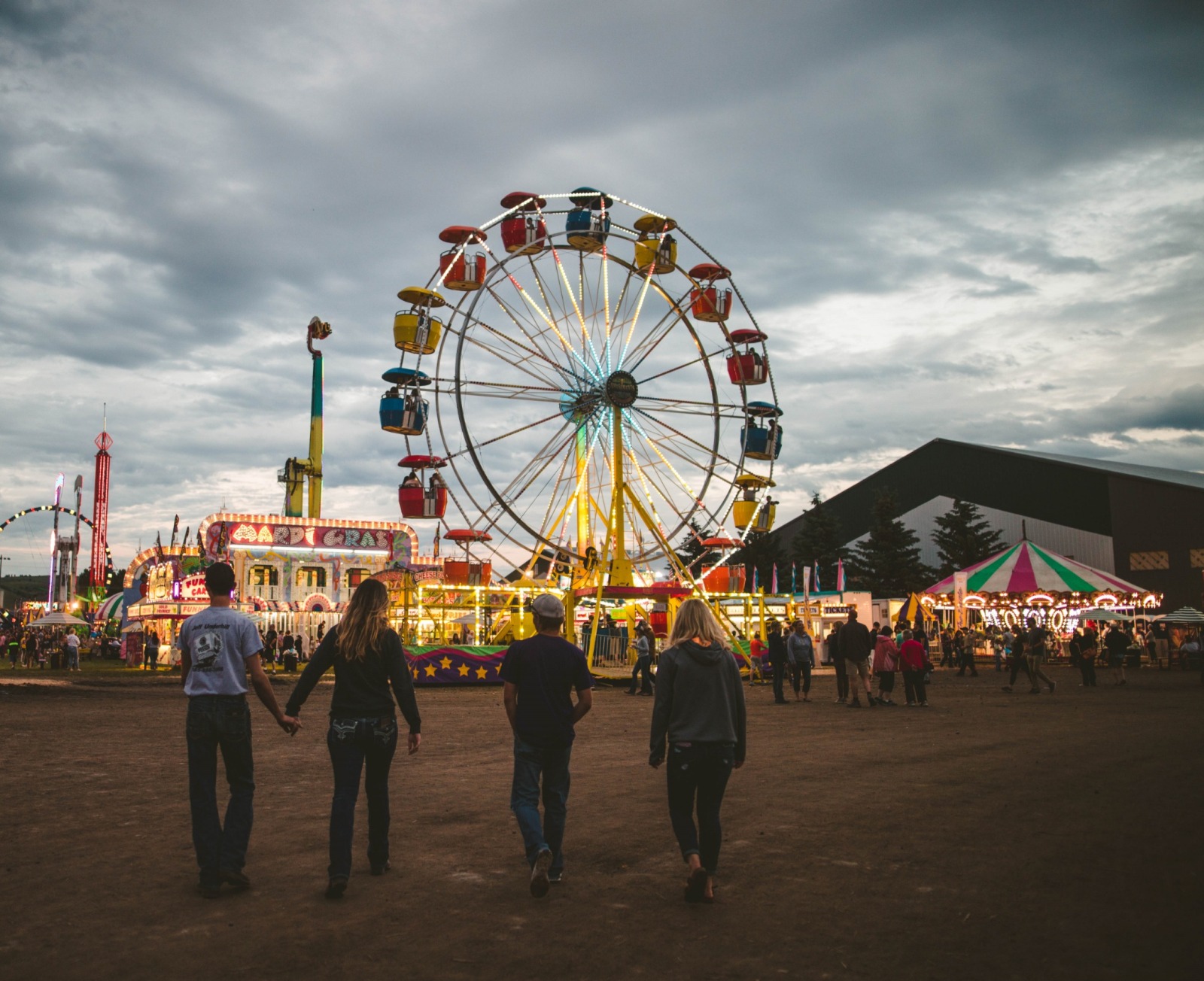 Four youth walking towards a ferris wheel at the Gallatin County State Fair