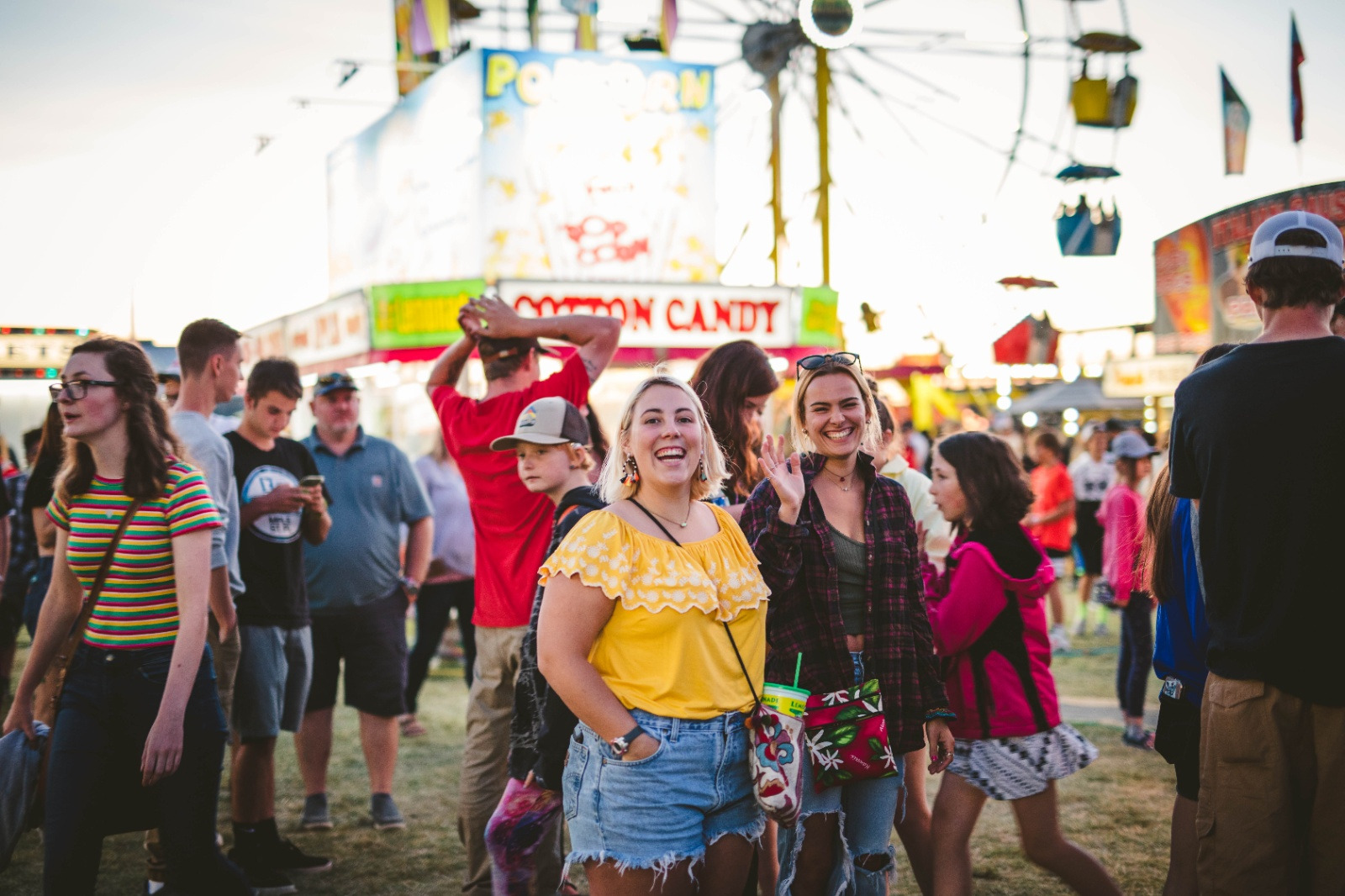 Two women smiling at the camera while standing in a crowd at the Gallatin County State Fair