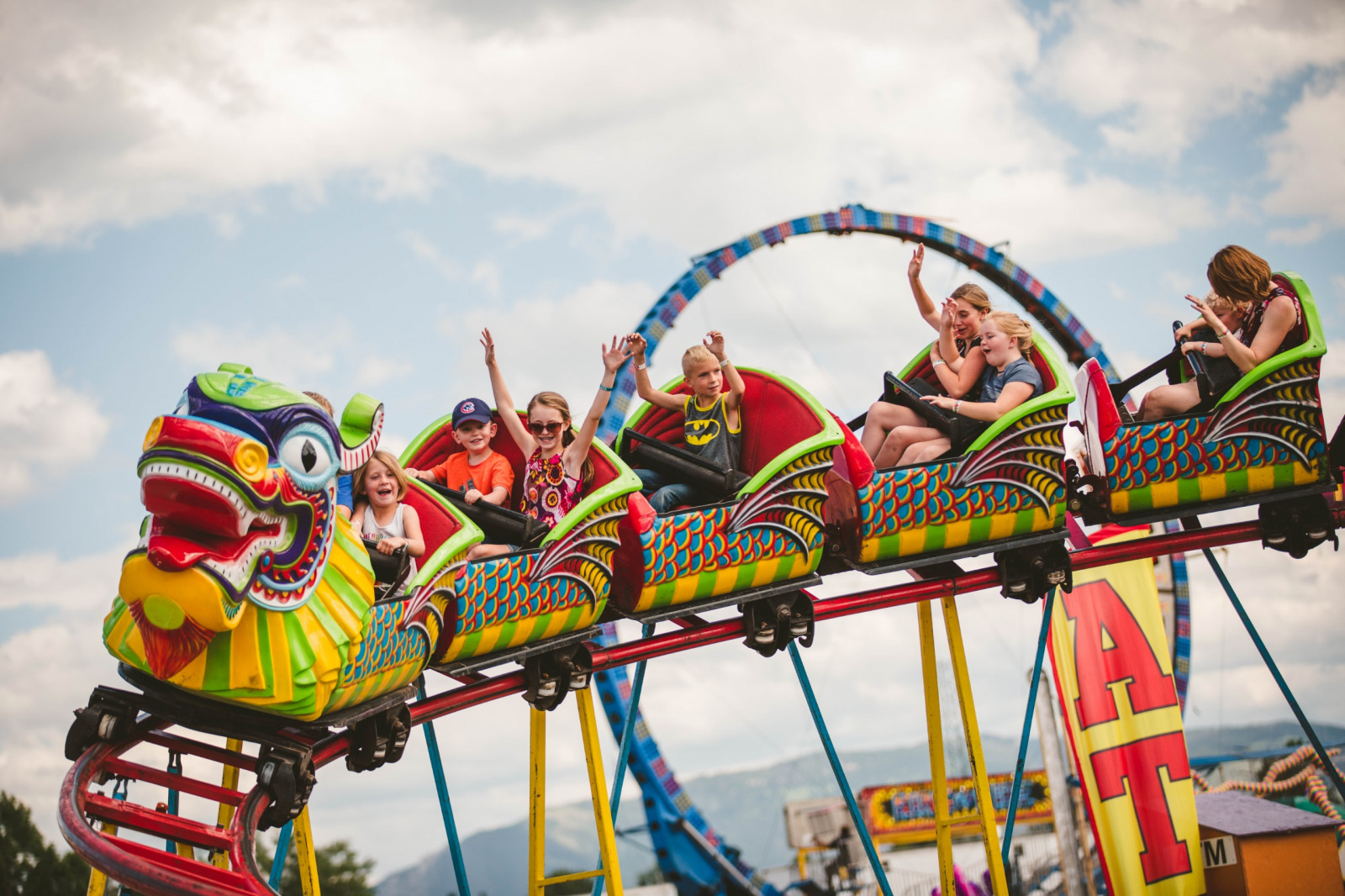 People riding a dragon shaped rollercoaster at the Gallatin County State Fair